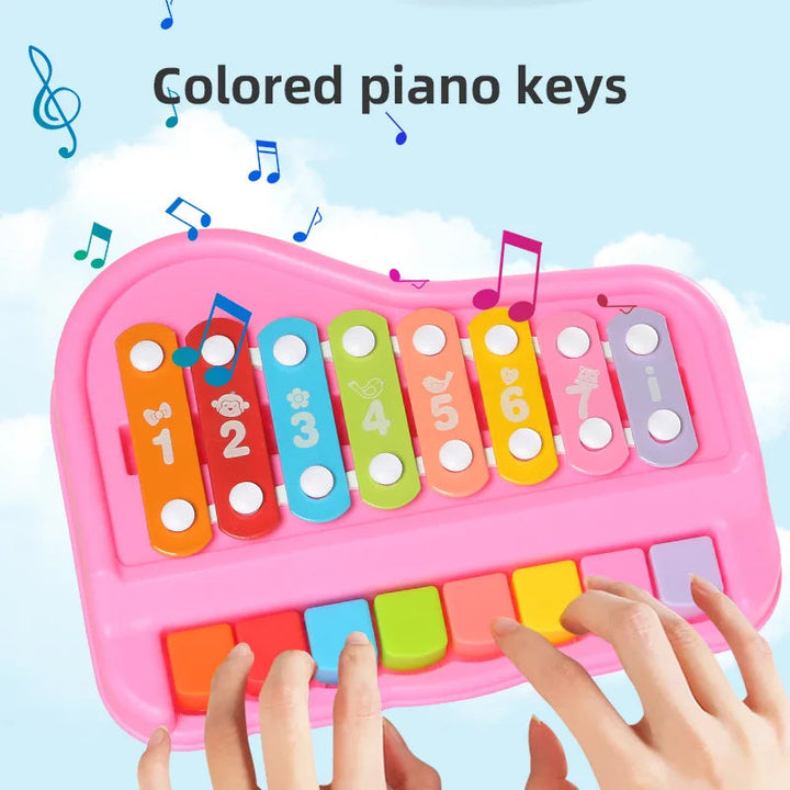 Hands pressing the colorful piano keys on a pink xylophone and piano toy