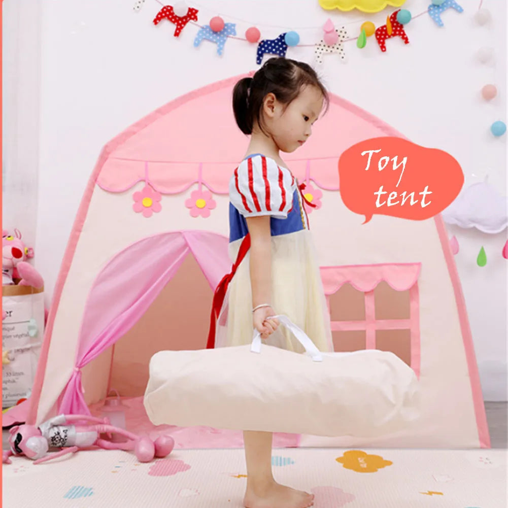 Child holding a storage bag beside a pink castle play tent
