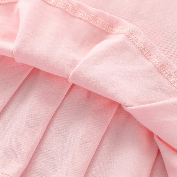 Pleats and inner stitching on the pink polo dress skirt.