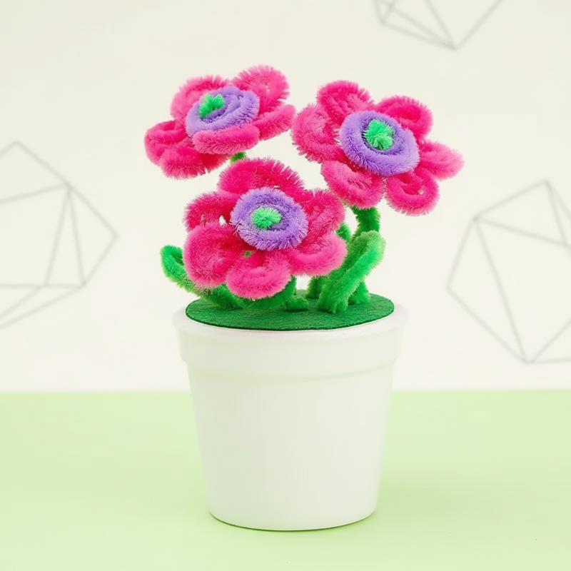Pink fuzzy-wire flowers with purple centers and green stems in a white pot