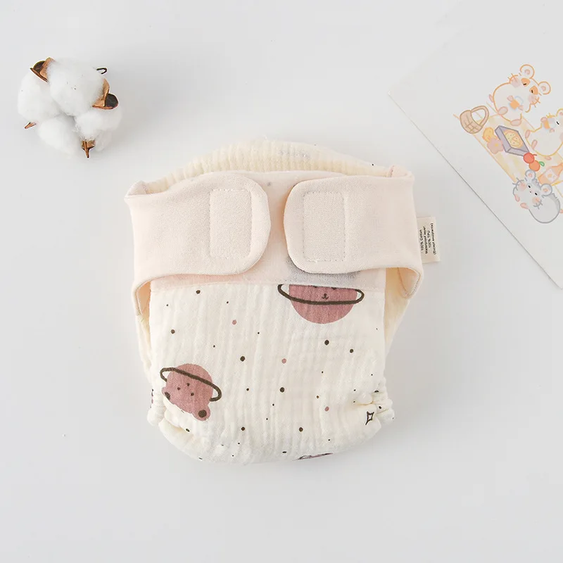Cloth diaper with pink ringed planets and small dot details