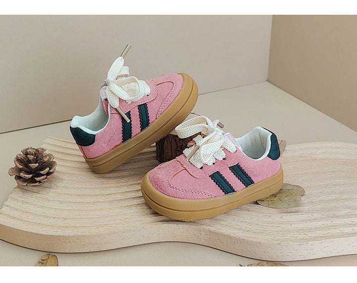 Pink lace-up sneakers with dark side stripes, pale linings and gum-colored soles