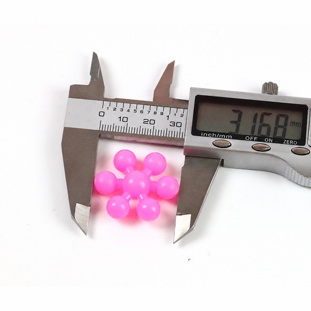 Digital caliper measuring a pink snowflake building block at 31.68 mm