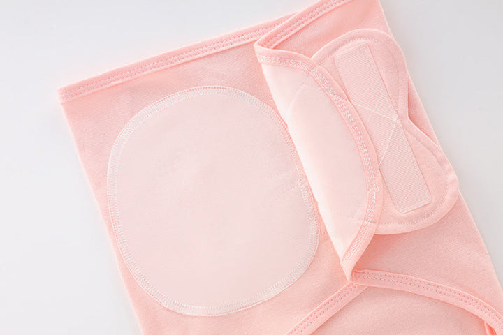 Pink swaddle blanket showing the adjustable hook-and-loop fastening patches