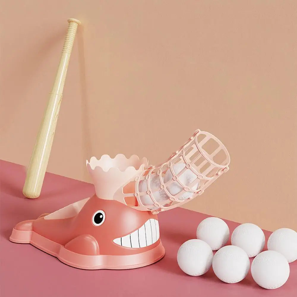 Pink whale-shaped baseball pitcher with a yellow bat and six white balls