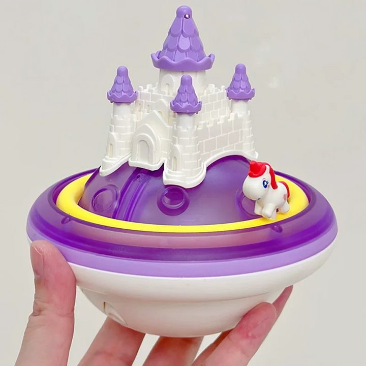 Purple unicorn castle bath toy held in one hand