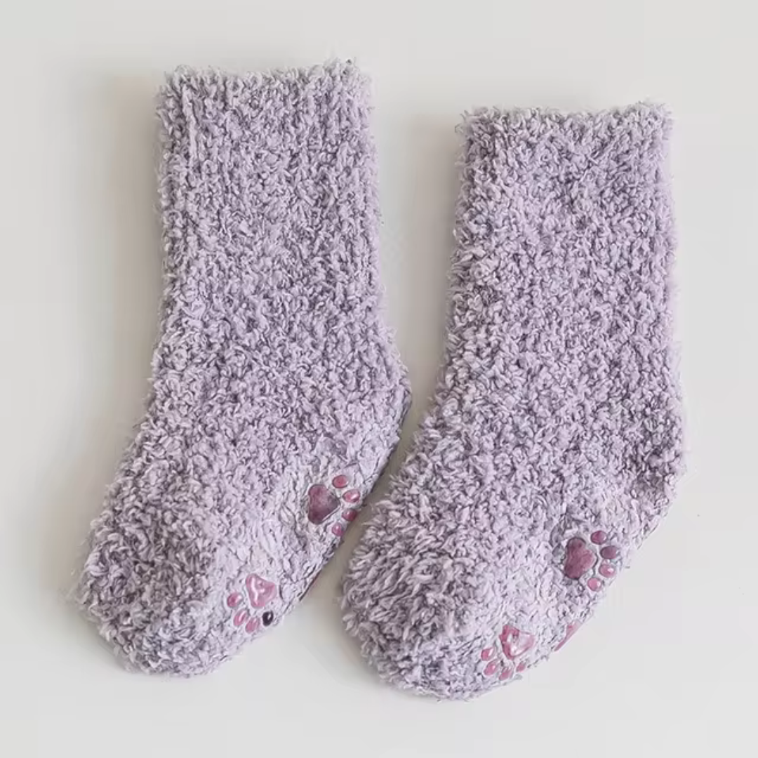 Purple fleece socks with paw-print details on the soles