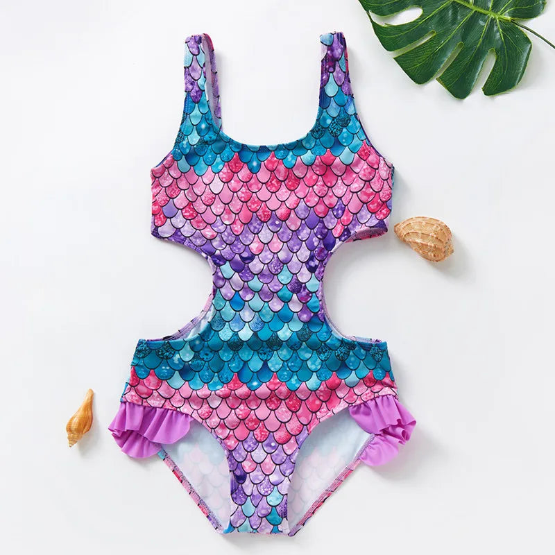 Purple, pink, and teal scale-print one-piece swimsuit with side cutouts and ruffled hips.