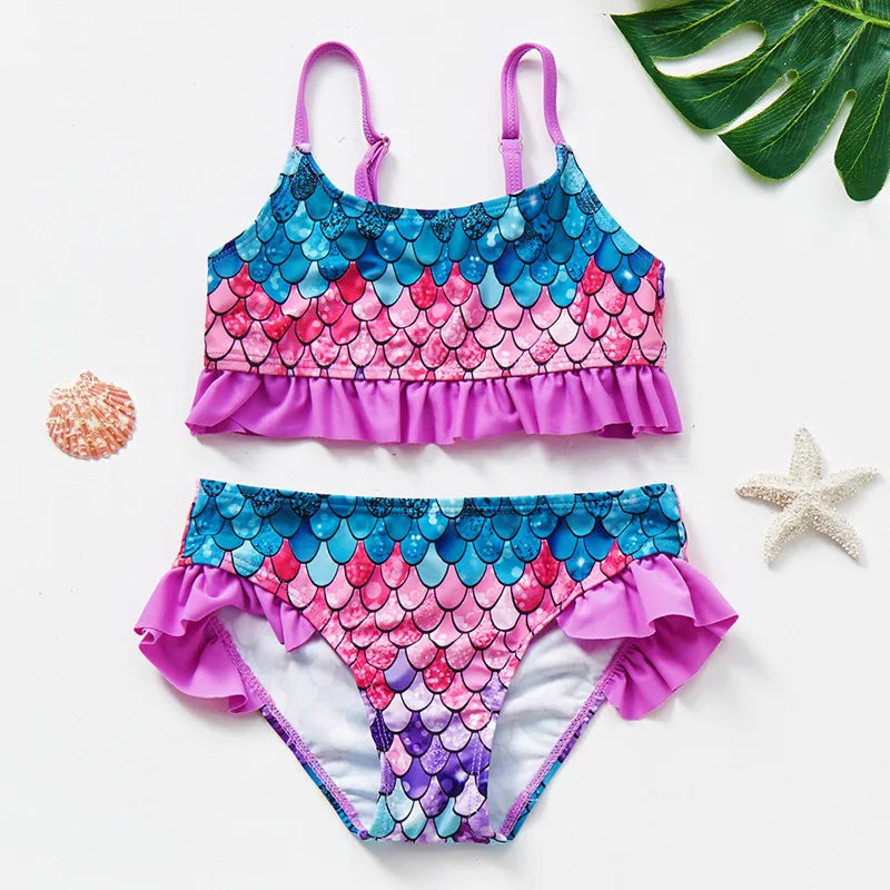Front of a purple, pink, and teal scale-print bikini with purple ruffles and thin straps.