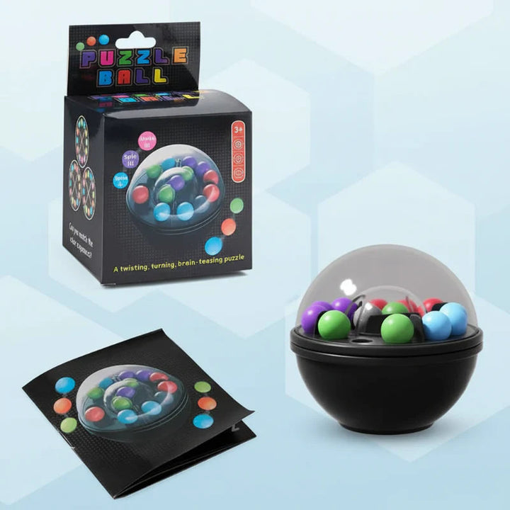 Clear-domed puzzle ball beside its booklet and box