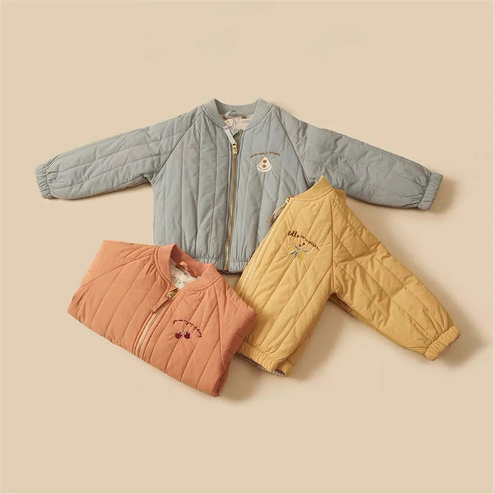 Blue, orange, and yellow quilted cotton winter coats arranged together, showing zip fronts and gathered hems