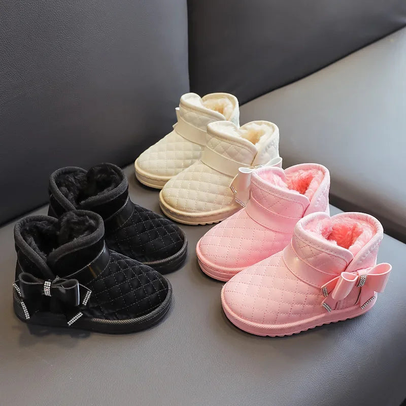 Pairs of girls' bow-detail winter boots in black, pink and cream white
