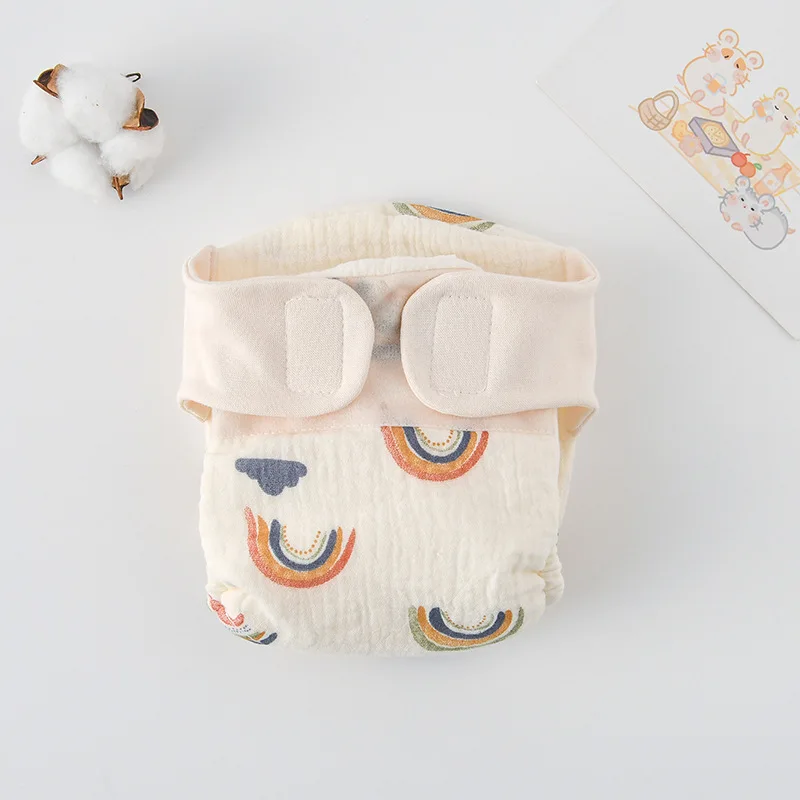 Rainbow-and-cloud cloth diaper with a cream hook-and-loop waistband