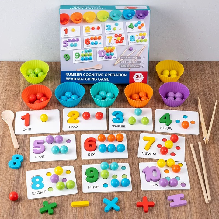 Counting and sorting game with colorful bowls, beads, number cards, and a spoon on a wooden table