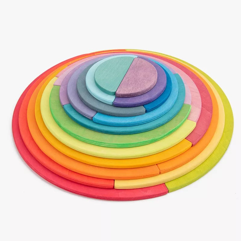 Rainbow and pastel wooden discs arranged in a layered circle