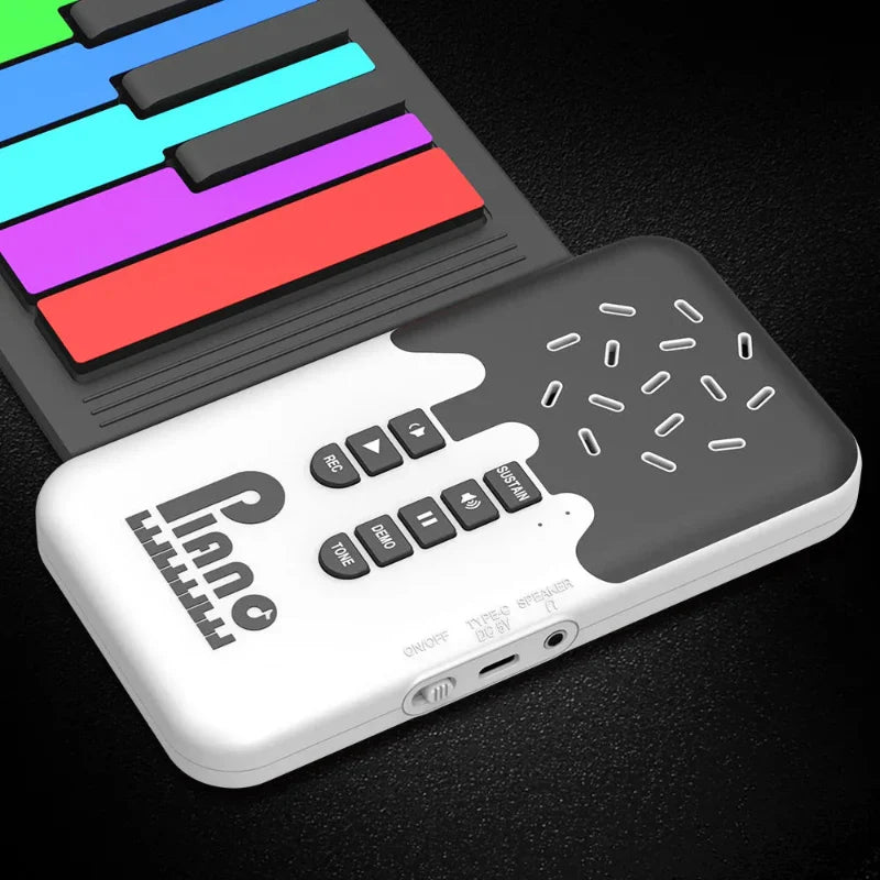 Close-up of rainbow piano keys beside the speaker, buttons, and side connections