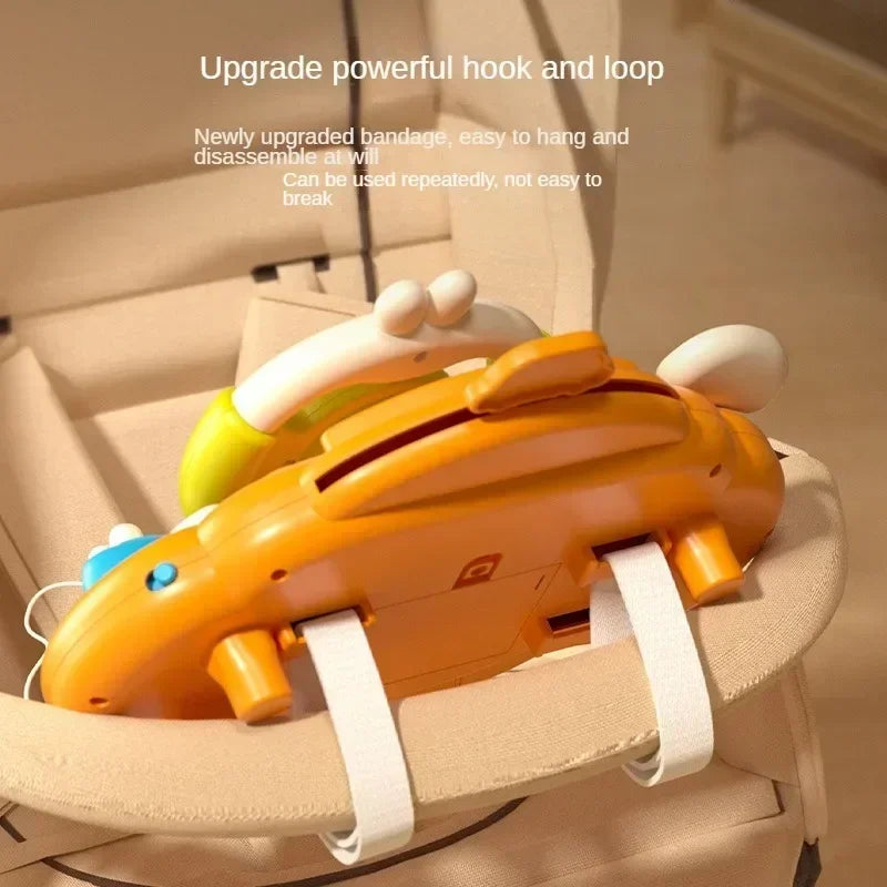 Rear view of the toy steering wheel attached to a stroller bar with hook-and-loop straps