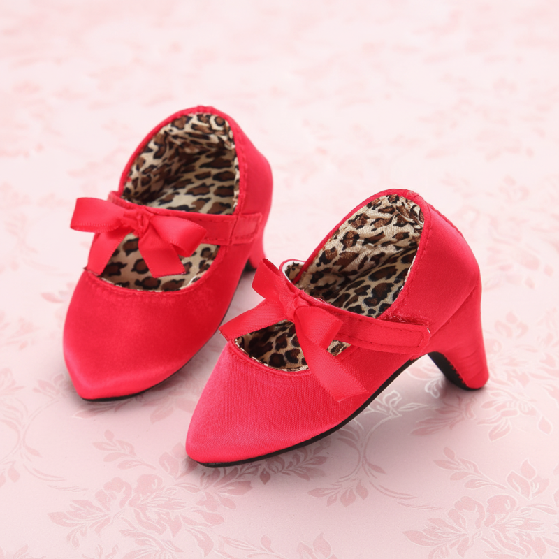 Red baby shoes with matching bows and leopard-print lining