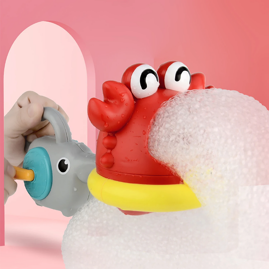 Red crab bath toy making a thick stream of foam with the attached hand-crank blower