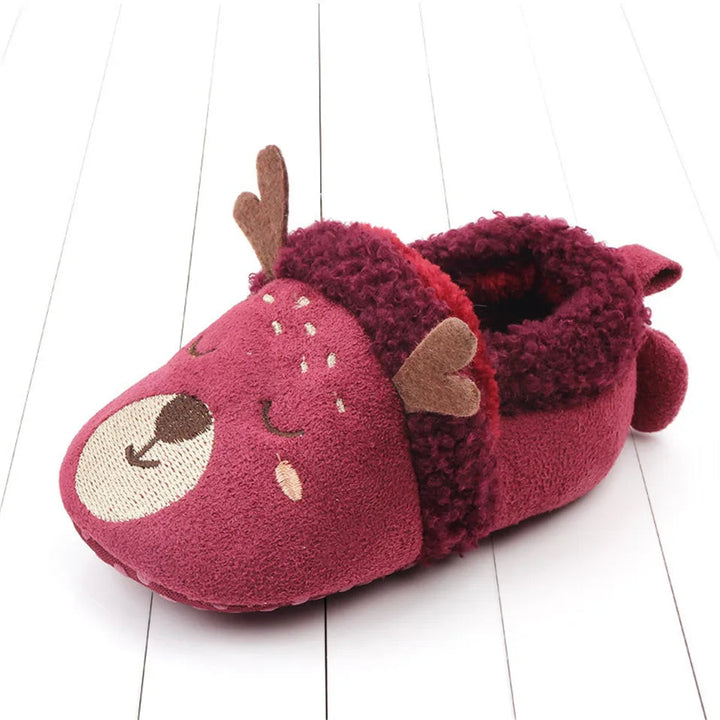 Red deer baby slipper with brown antlers and fuzzy trim.