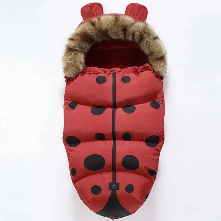 Red ladybug-pattern stroller footmuff with black spots and a faux fur collar