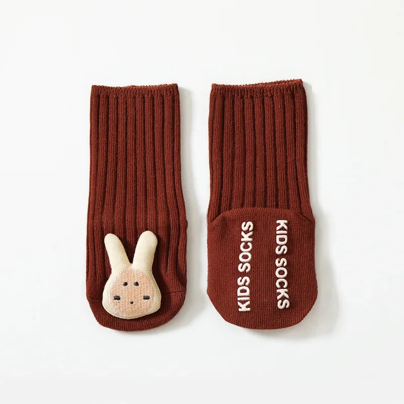 Red rabbit baby socks with ribbed cuffs and white lettering on the non-slip sole