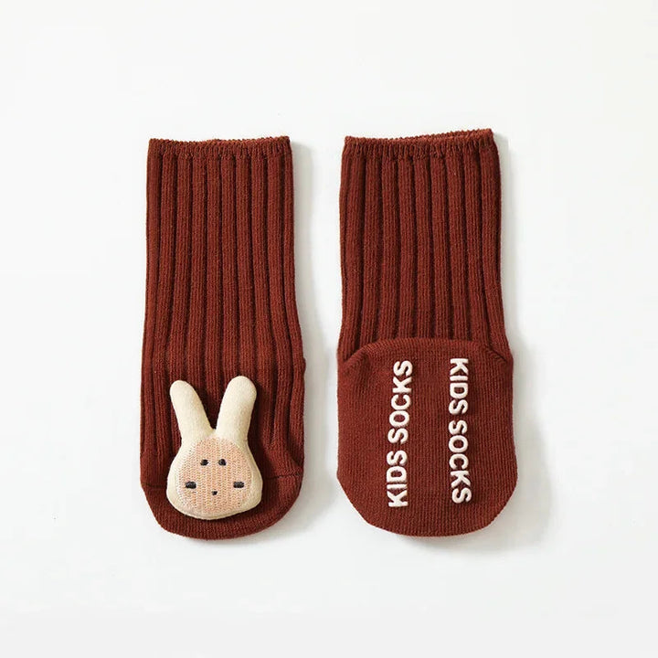 Red rabbit baby socks with ribbed cuffs and white lettering on the non-slip sole