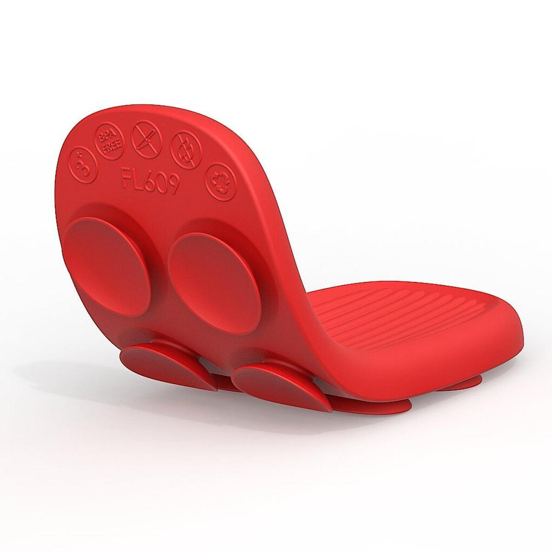Red silicone sensory strip bent into a curve to show the ridged face and suction-cup back.