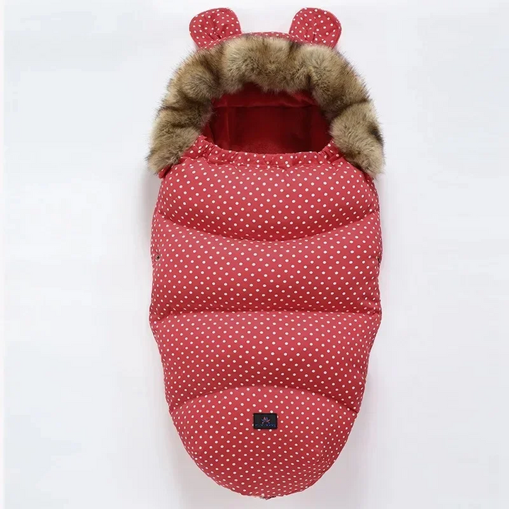 Red stroller footmuff with white polka dots, matching ears, and a faux fur collar