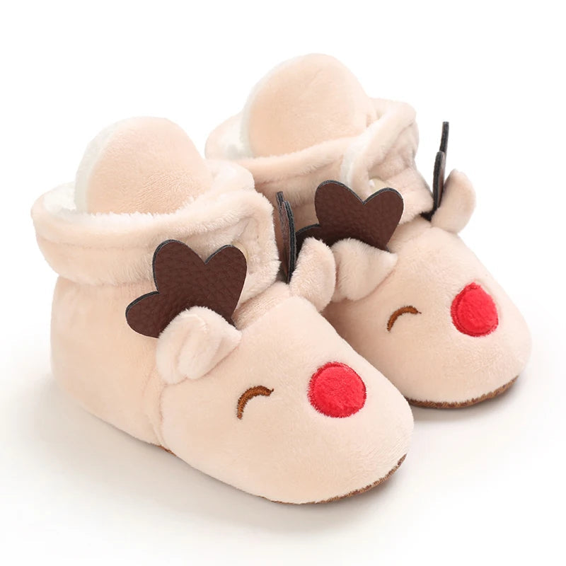 Beige reindeer baby slippers with brown antlers, closed eyes, and red noses