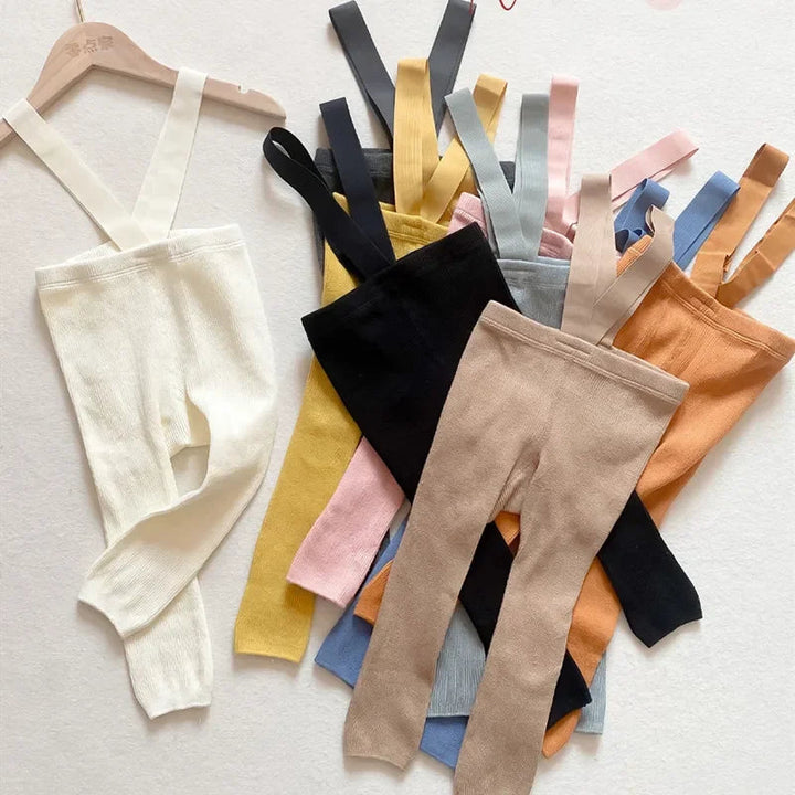 Ribbed baby leggings with suspenders arranged in a range of colors