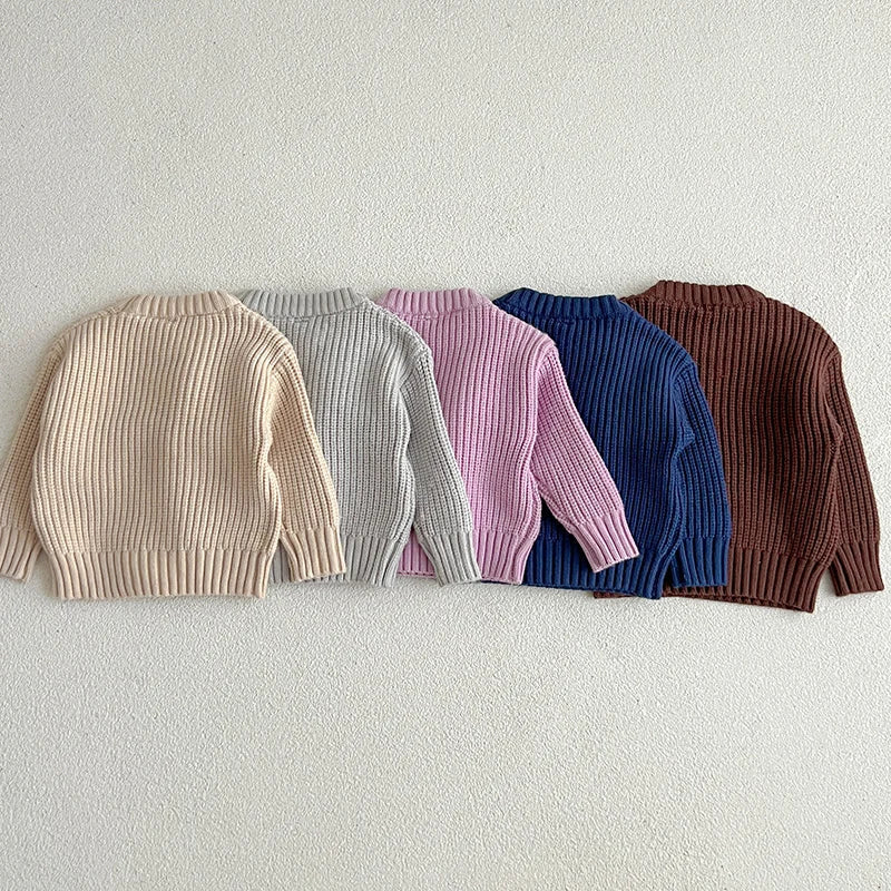 Back views of apricot, gray, purple, dark blue, and brown ribbed knit sweaters.