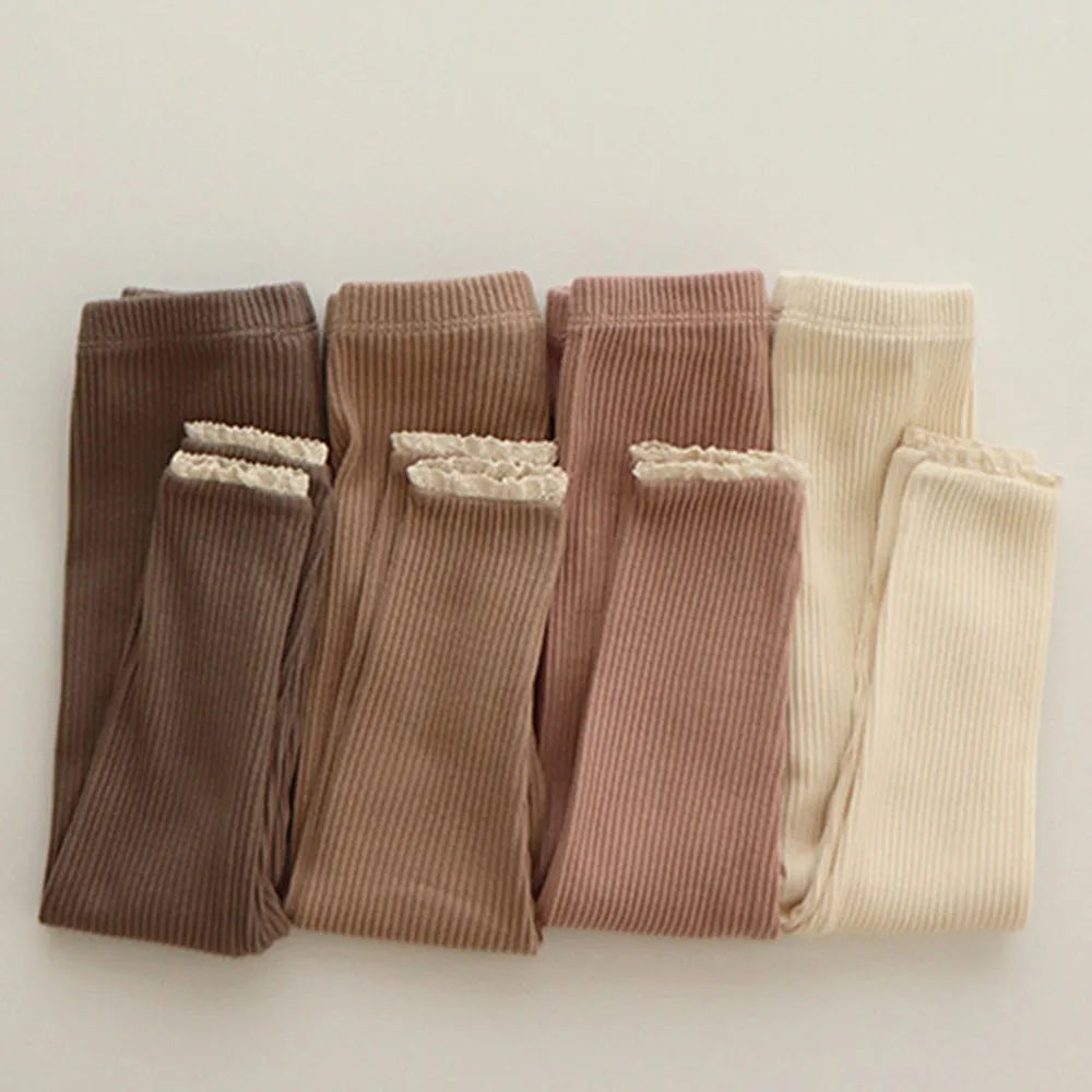 Brown, khaki, pink and beige ribbed leggings with lace-trimmed cuffs arranged side by side.