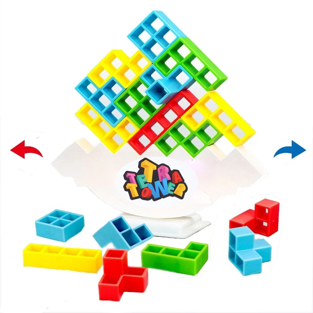 Rocking block tower with loose red, blue, green, and yellow pieces arranged below.