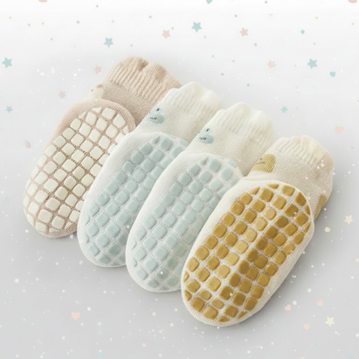 Undersides of baby socks showing rows of rubber grip dots in several colors.