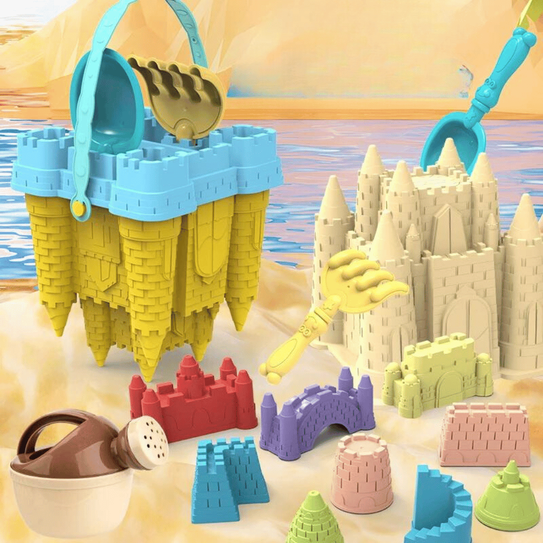 Yellow castle-shaped bucket and colorful sand tools beside molded sandcastles on a beach