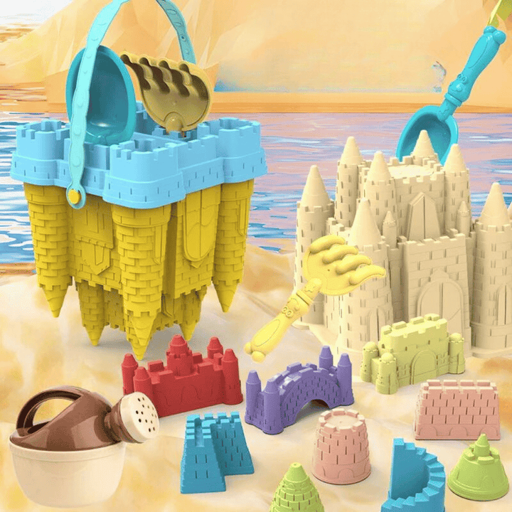 Yellow castle-shaped bucket and colorful sand tools beside molded sandcastles on a beach