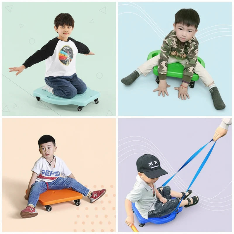 Children seated and kneeling on wheeled scooter boards, with one board being pulled by a rope