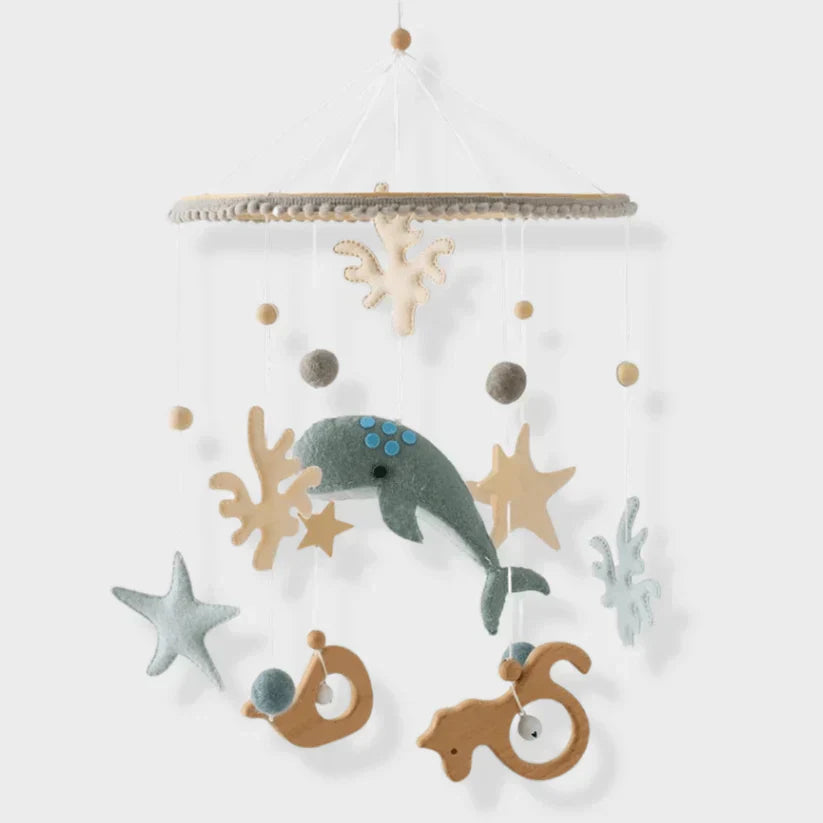 Seabed baby mobile with a teal whale, starfish, seahorses, and coral shapes