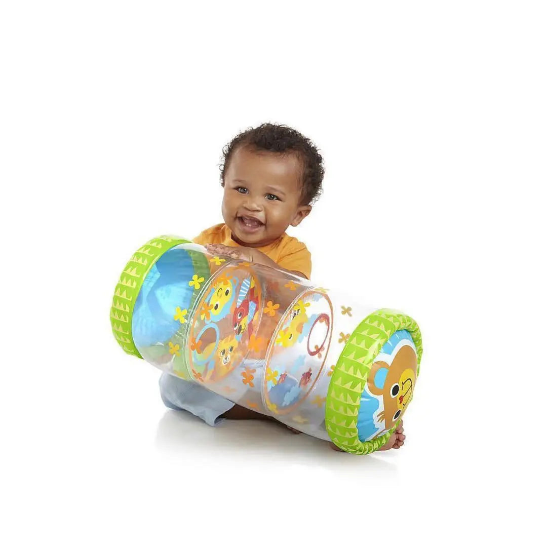 Seated baby holding a green inflatable roller with animal illustrations