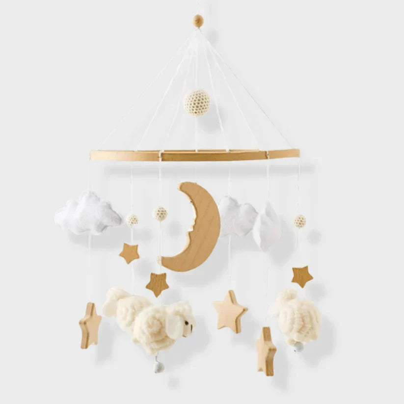 Sheep baby mobile with a wooden crescent moon, stars, white clouds, and cream-colored sheep