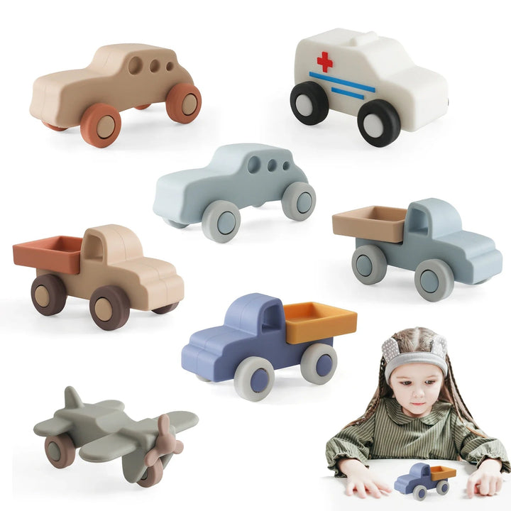 Silicone toy cars, trucks, an ambulance and an airplane, with a child playing with a truck