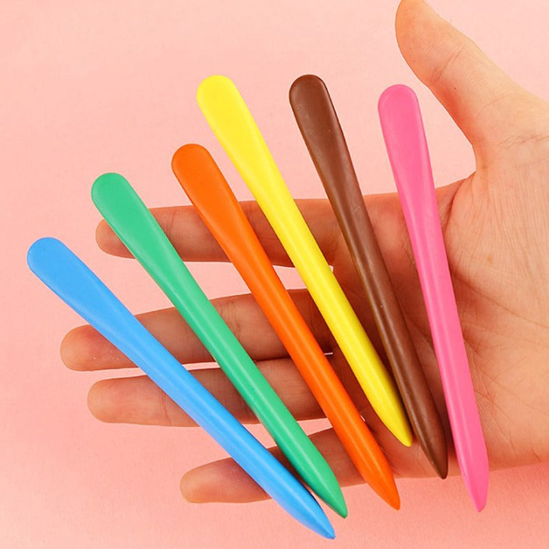 Six slim crayons in bright colors held in an open hand