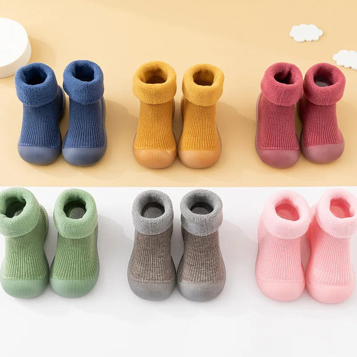 Sock shoes in six colors, each with a ribbed upper and soft folded cuff.