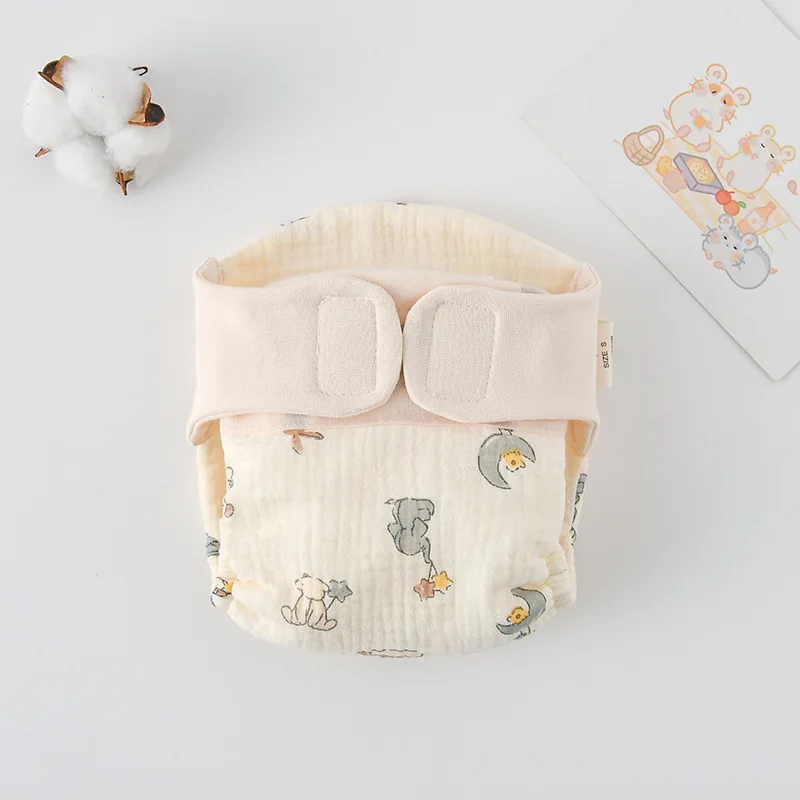 Cloth diaper with space-themed animal illustrations and a cream waistband