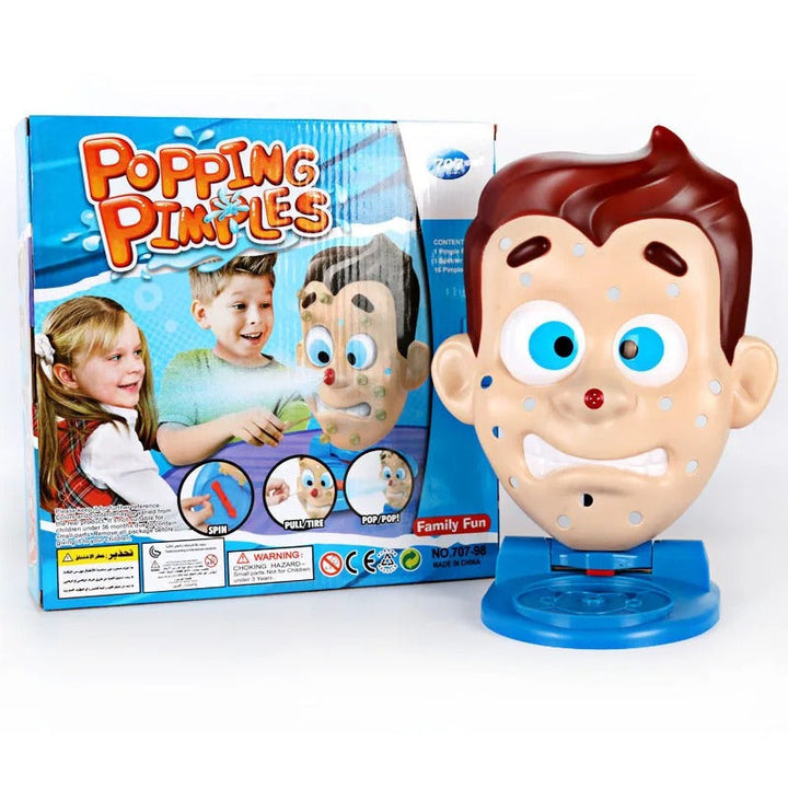Pimple-face family game on a blue base beside its packaging
