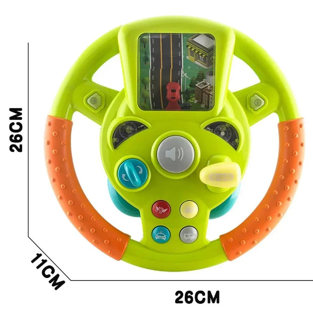 Green steering wheel toy with measurements showing 26 cm height, 26 cm width, and 11 cm depth
