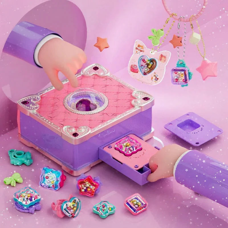 Pink-and-purple jewelry craft station with a pull-out drawer and colorful finished charms.