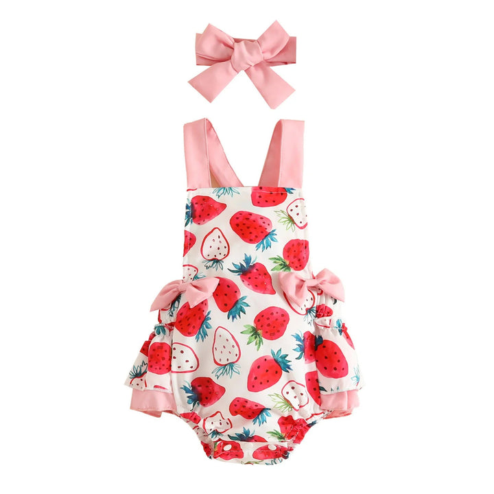 Strawberry-print romper and pink bow headband shown against a white background