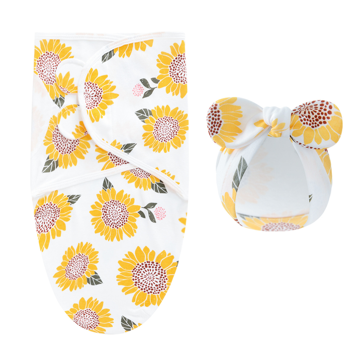 White swaddle blanket and matching bow hat with large yellow sunflowers